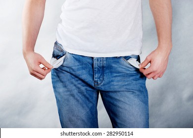 Young Poor Man With Empty Pockets.