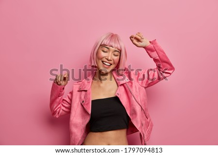 Similar – Image, Stock Photo Young adult asian female wearing glasses in front of neon light sign, shallow selective focus