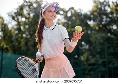 Young Positive Caucasian Tennis Player On Hardcourt During Game At Summer Day, Fit And Slim Adult Lady In Uniform Enjoy Sport Game,Preparing For Competition. Professional Athlete Portrait