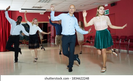 Young positive people dancing tap dance in pairs in studio.. - Powered by Shutterstock