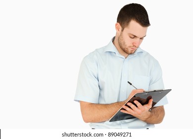 Young Post Employee Taking Notes Against A White Background