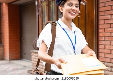 Young Postwoman With Letters Outdoors