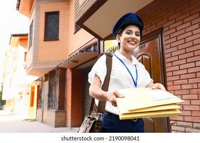 Young Postwoman With Letters Outdoors