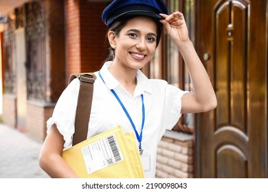 Young Postwoman With Letters Outdoors