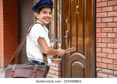 Young Postwoman With Letters Outdoors