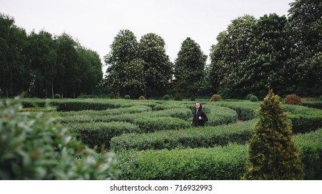 Young and powerful guy is running through big and green labyrinth. He has enough strenght to cross it and reach the finish line.