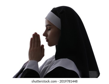 Young praying nun on white background