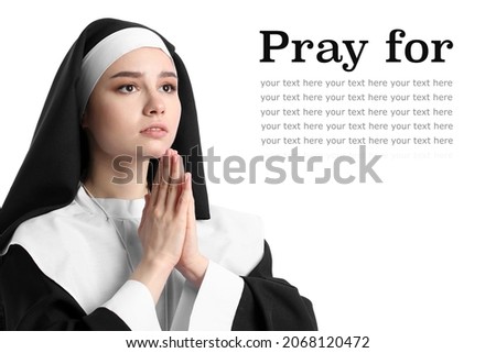 Young praying nun on white background with space for text