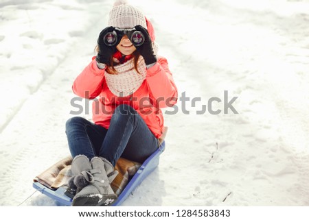 young and preety girl walking in a winter park