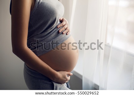 Similar – Image, Stock Photo Pregnant woman holding her tummy