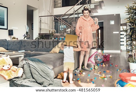Young pregnant mother and her little daughter, at home