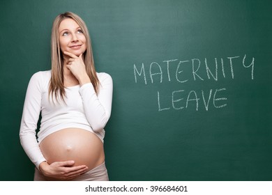 Young pregnant woman and a blackboard with copyspace