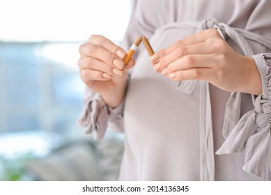 Young pregnant woman with broken cigarette, closeup. Concept of refusing from bad habit - Powered by Shutterstock