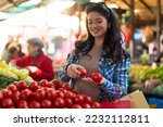 Young pregnant woman buying on a street market