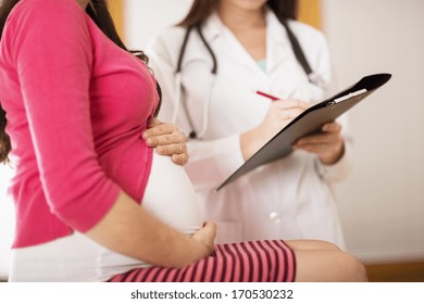 Young Pregnant Woman With Doctor In Hospital.