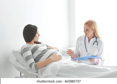 Young Pregnant Woman With Doctor At The Hospital