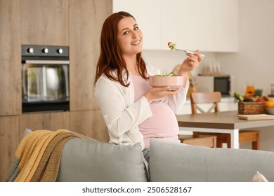 Young pregnant woman eating fresh vegetable salad at home - Powered by Shutterstock