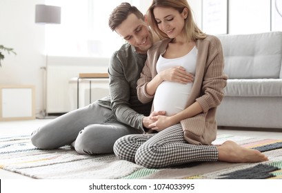 Young Pregnant Woman With Her Husband At Home