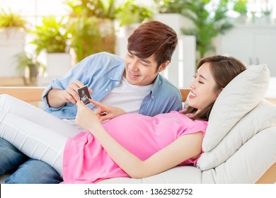 young pregnant woman with her husband looking  ultrasound photo and expecting the baby - Powered by Shutterstock