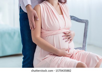young pregnant woman with her husband expecting the baby. Pregnancy, maternity, preparation and expectation concept. Beautiful tender mood photo of pregnan.
