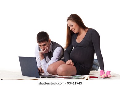 The Young Pregnant Woman With Her Husband Plan The Family Budget On A White Background.