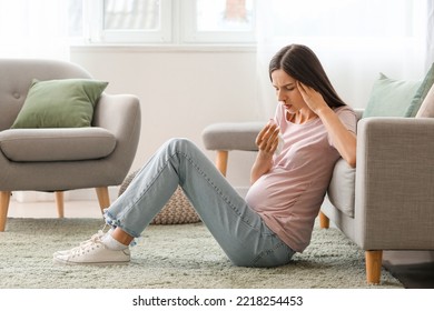 Young Pregnant Woman With Nosebleed And Tissue At Home