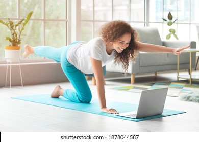 Young pregnant woman practicing yoga at home - Powered by Shutterstock