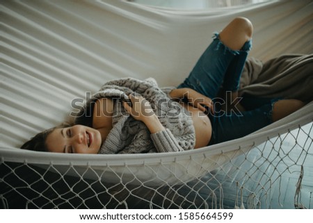 Similar – Young adult couple kissing each other on couch