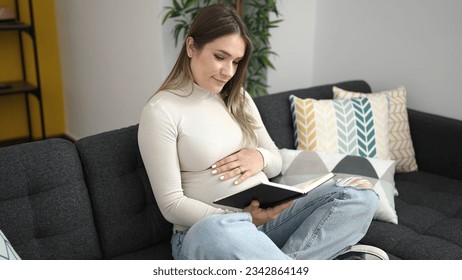 Young pregnant woman reading book touching belly at home - Powered by Shutterstock