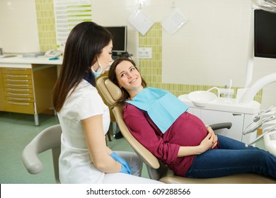 Young Pregnant Woman Seating In Dentist Chair