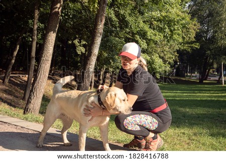 Similar – Foto Bild Frau mit blondem Labrador auf der Lichtung