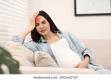 Young pregnant woman suffering from headache at home - Powered by Shutterstock