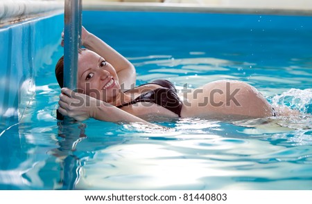 Young pregnant woman in swimming pool