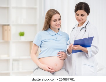 Young pregnant woman taking consultation at doctor's office.