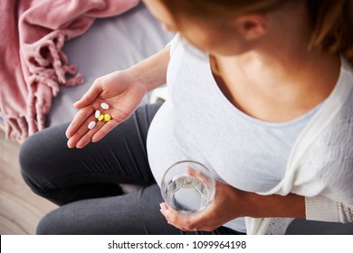 Young Pregnant Woman Taking Medicine 