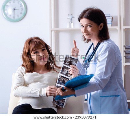 Young pregnant woman visiting experienced doctor gynecologist