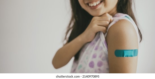 Young Preteen Girl Showing Her Arm With Bandage After Got Vaccinated Or Inoculation, Child Immunization, Covid Omicron Vaccine Concept