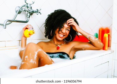 young pretty african american girl taking bath with foam, lifest