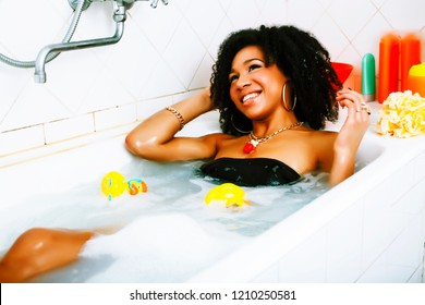 young pretty african american girl taking bath with foam, lifest