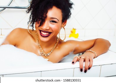 young pretty african american girl taking bath with foam happy smiling, lifestyle people concept