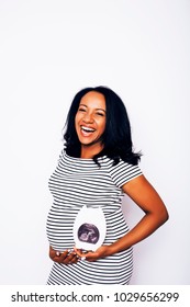 young pretty african american woman pregnant happy smiling, posing on white background isolated, lifestyle people concept copyspace 