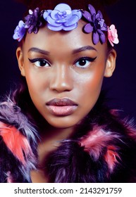 Young Pretty African American Woman In Spotted Fur Coat And Flowers On Head Smiling On Black Background, Fashion People Concept