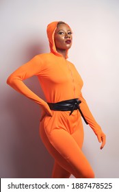 A young pretty african lady in an orange jumpsuit suit - Shutterstock ID 1887478525