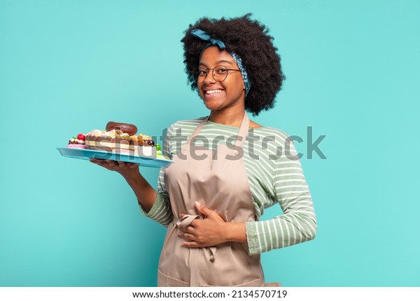 young pretty afro\
woman baker with cakes