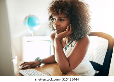 Young Pretty Afro-american Woman Using Small Business Computer And Smiling On Blurred Inside Background. 