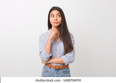 Young pretty arab woman looking sideways with doubtful and skeptical expression. - Shutterstock ID 1408704959
