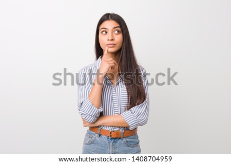 Young pretty arab woman looking sideways with doubtful and skeptical expression. Zdjęcia stock © 