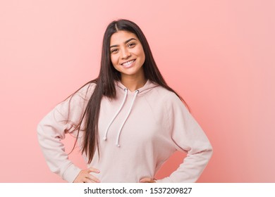Young pretty arab woman wearing a casual sport look confident keeping hands on hips.