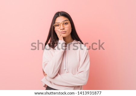 Young pretty arab woman wearing a casual sport look who is bored, fatigued and need a relax day.