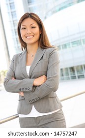 A young, pretty asian business woman at office building